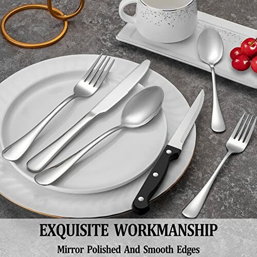 Elegant silverware set with polished forks, spoons, and knives on a table setting.