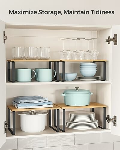 Organized kitchen cabinet with stacked dishes and cookware.