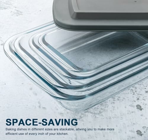 Stackable glass baking dishes with lids on a textured surface.