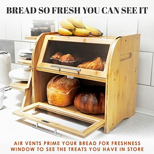 Wooden bread box with glass window containing bread and pastries.
